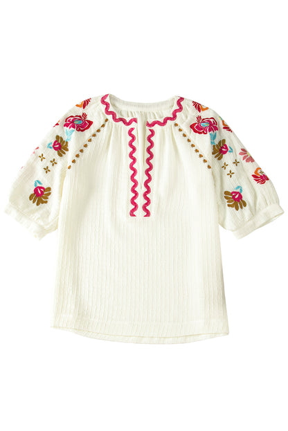 Beigefarbene Bluse mit floraler Stickerei und strukturierten Puffärmeln im Ricrac-Stil