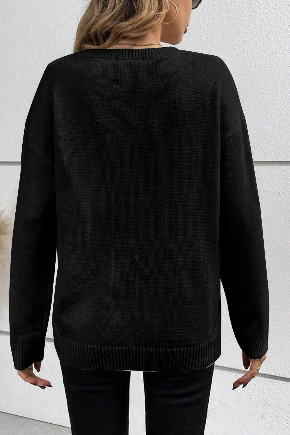 Schwarzer Pullover mit überschnittener Schulter und geripptem Rand und Boo-Strickmuster