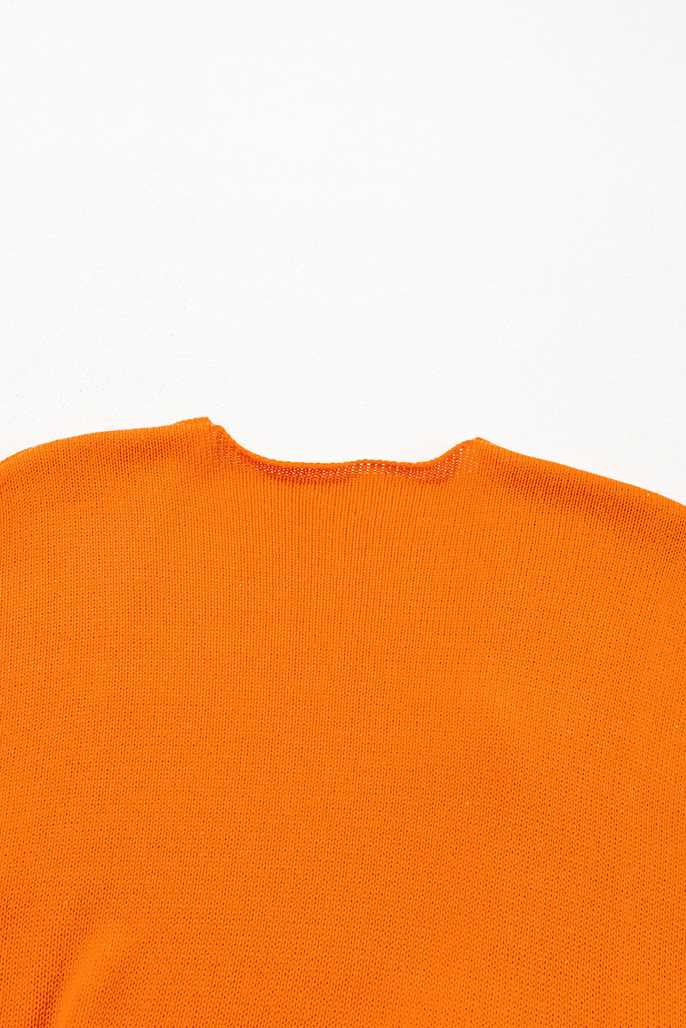 Orangefarbener, lockerer Strickcardigan mit Blumenmuster und offener Vorderseite