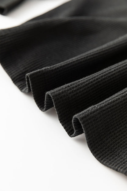 Schwarze Bluse mit Pailletten-Patchwork und Laternenärmeln