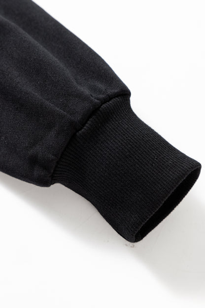 Schwarzes Lametta-Sweatshirt mit Game Day-Grafik und überschnittener Schulter