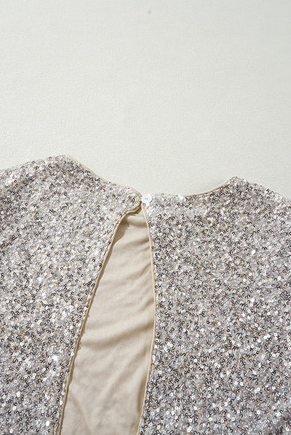 Silberne Bluse mit Pailletten, Puffärmeln und Cut-Out am Rücken