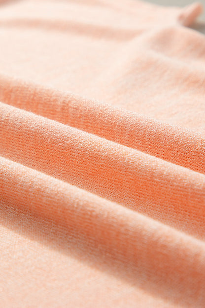 Aprikosenrosa Lässiges T-Shirt mit Fledermausärmeln und Knopfdetail