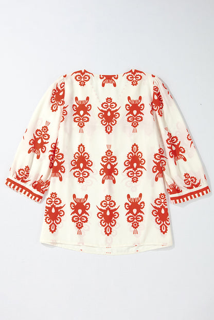 Orangefarbene Bluse mit 3/4-Ärmeln und V-Ausschnitt im Vintage-Stil mit geometrischem Muster