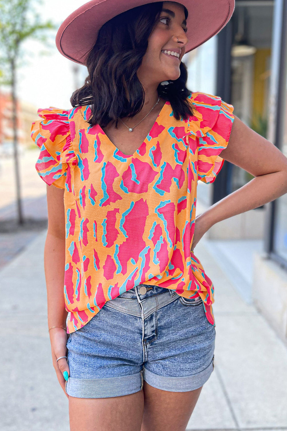 Orangefarbene Bluse mit abstraktem Print und V-Ausschnitt und Rüschenärmeln