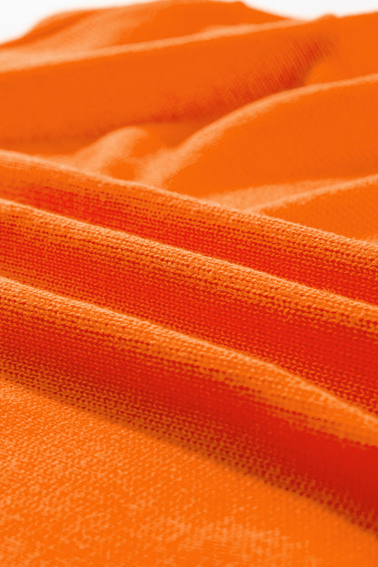 Orangefarbener, lockerer Strickcardigan mit Blumenmuster und offener Vorderseite