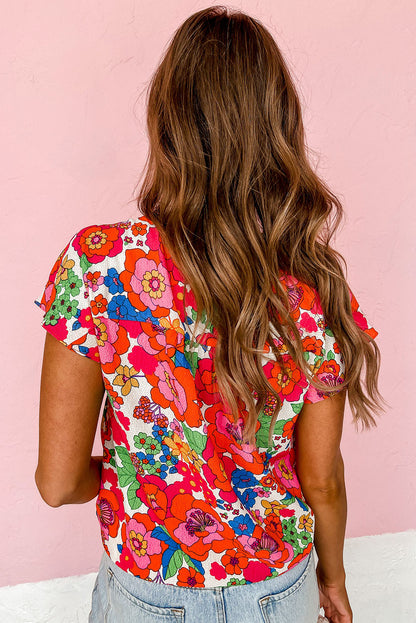 Feurig rotes Top mit Blumenmuster und Schlitz am Ausschnitt