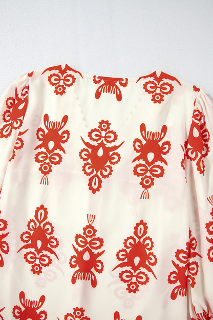Orangefarbene Bluse mit 3/4-Ärmeln und V-Ausschnitt im Vintage-Stil mit geometrischem Muster