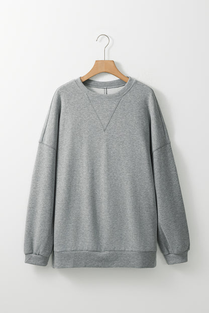 Mittelgraues Oversize-Oberteil mit seitlichem Schlitz und überschnittener Schulter