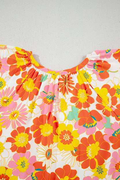 Orangefarbene Bluse mit V-Ausschnitt und halblangen Ärmeln und abstraktem Print