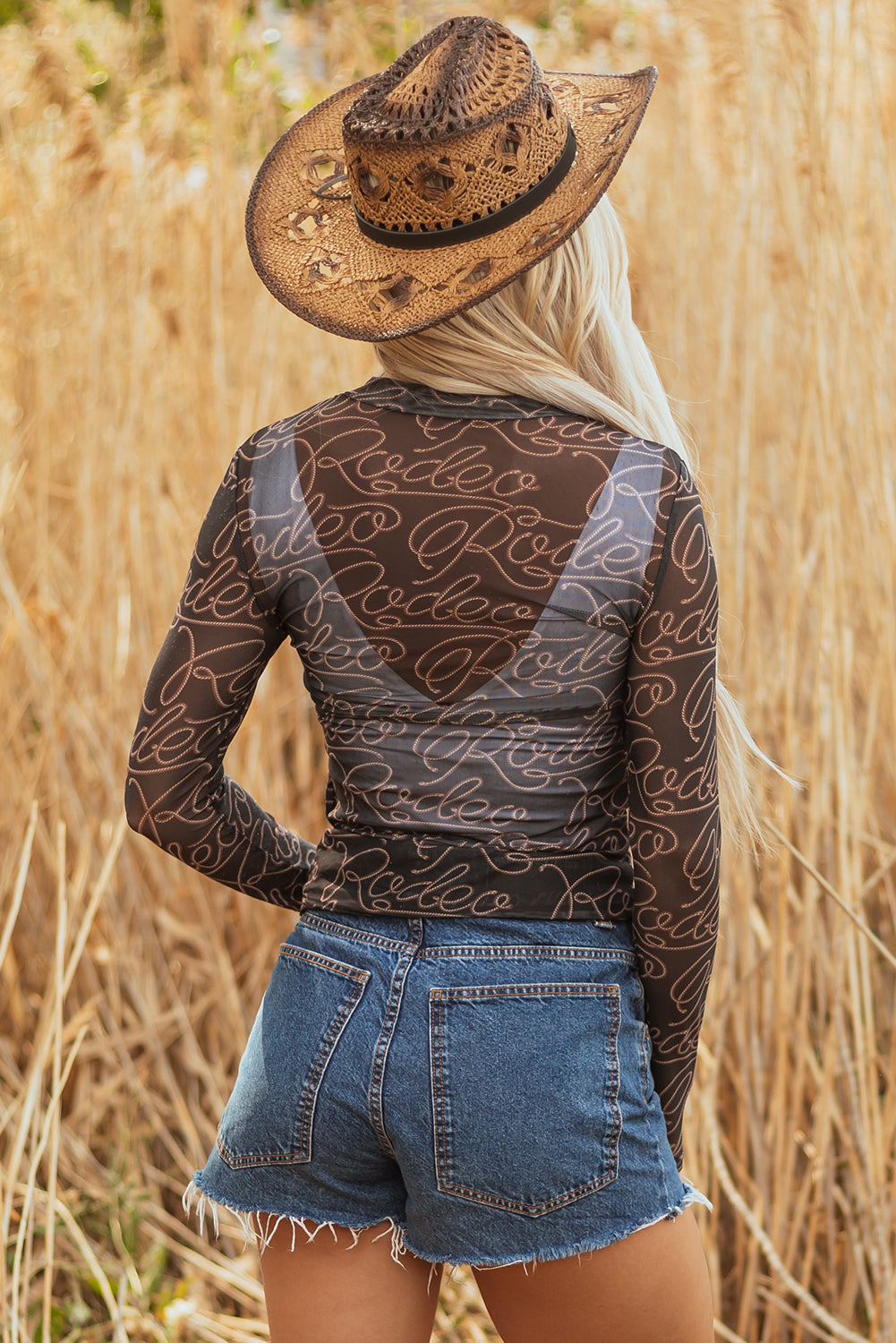Schwarzes, langärmliges Netzoberteil mit Stehkragen und Western-Rodeo-Print