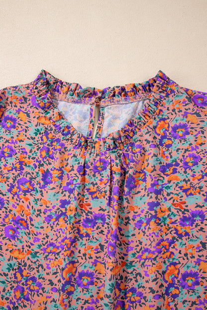 Lila Bluse mit Rundhalsausschnitt, Blumenmuster und gerafften Bündchen