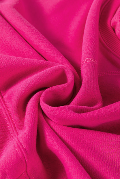 Rosarotes, lockeres Sweatshirt mit überschnittenen Schultern, überkreuzten Nähten und Taschen