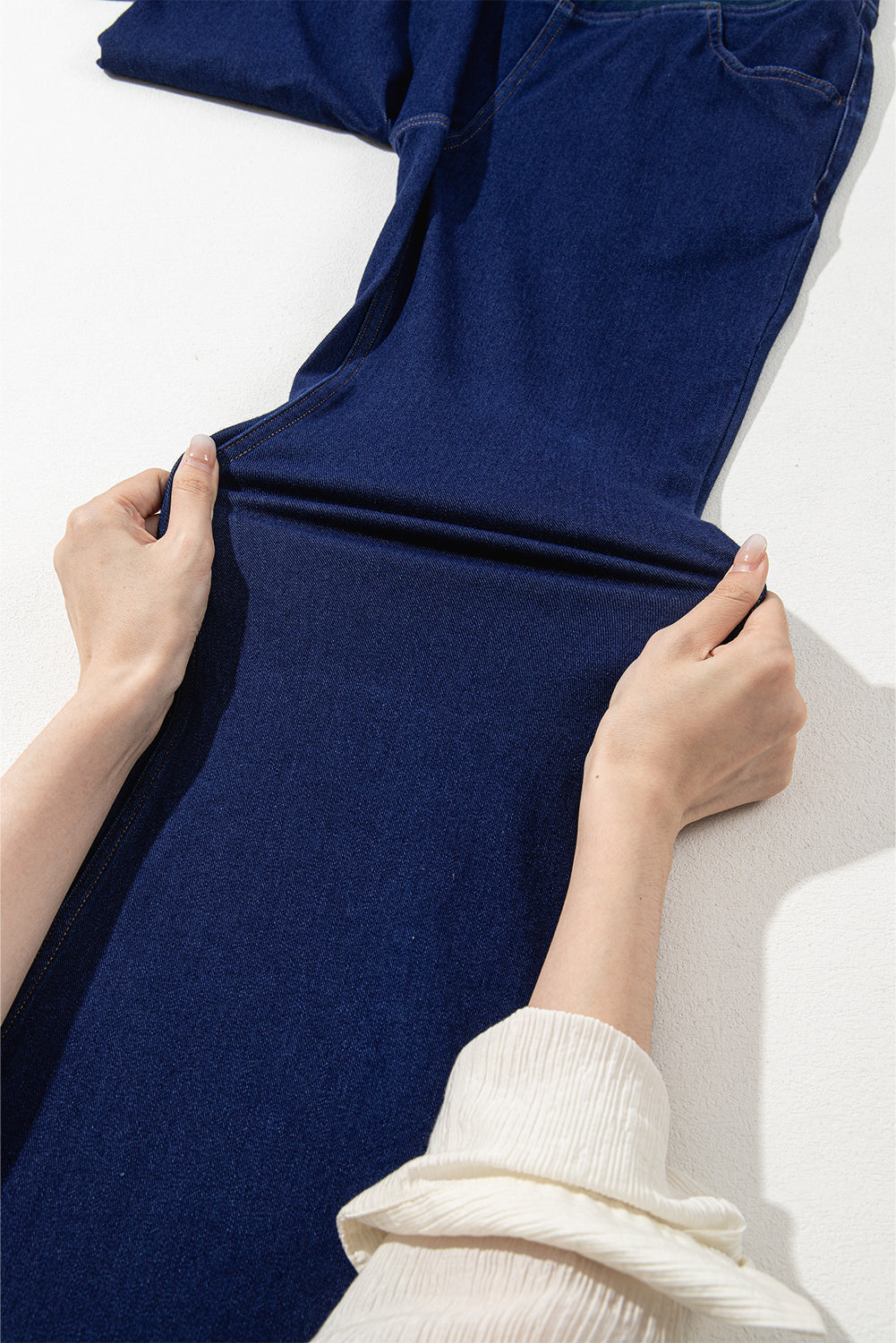 Dunkelblaue, einfarbige Schlagjeans mit gekreuzter High Waist