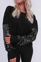 Schwarze Bluse mit Pailletten-Patchwork und Laternenärmeln