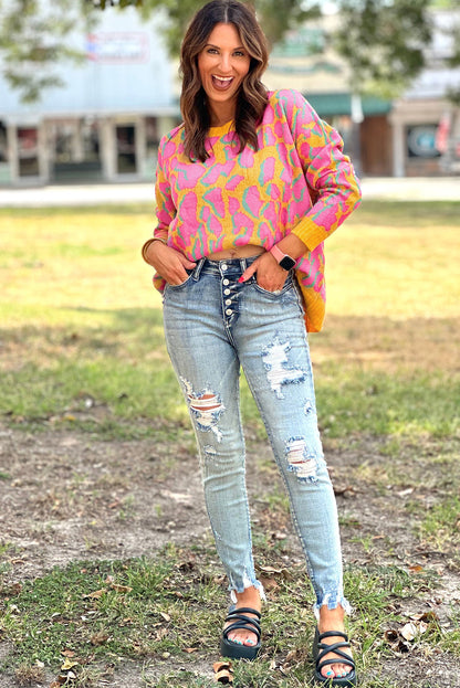 Vitality – Orangefarbener Baggy-Pullover mit abstraktem Print und geripptem Saum