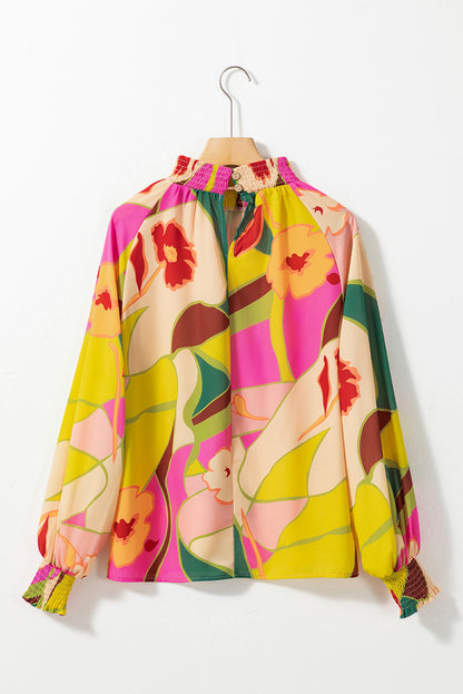 Bluse mit mehrfarbigem Blumenmuster, gesmoktem Saum und Stehkragen