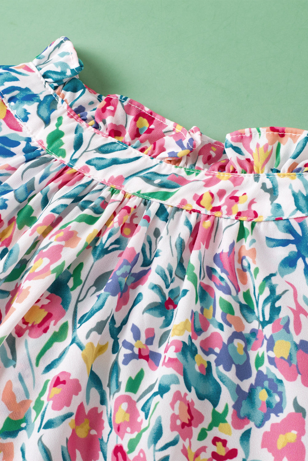 Rosa Bluse mit Blumenmuster, Knöpfen, Schlitz am Ausschnitt und Puffärmeln