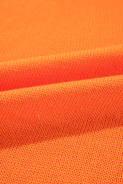 Orangefarbener, lockerer Strickcardigan mit Blumenmuster und offener Vorderseite