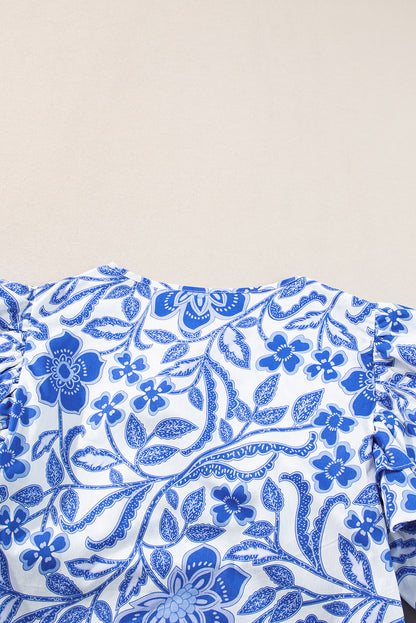 Dunkelblaue Bluse mit Blumenmuster und Rüschen und Puffärmeln