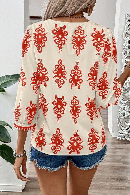 Orangefarbene Bluse mit 3/4-Ärmeln und V-Ausschnitt im Vintage-Stil mit geometrischem Muster