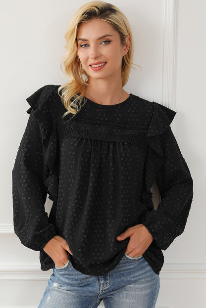 Schwarze Bluse mit langen Ärmeln und Ösen an der Schulter aus Spitze und Rüschen