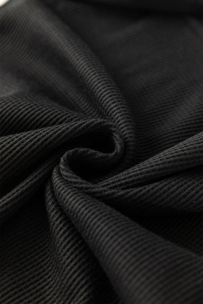 Schwarze Bluse mit Pailletten-Patchwork und Laternenärmeln