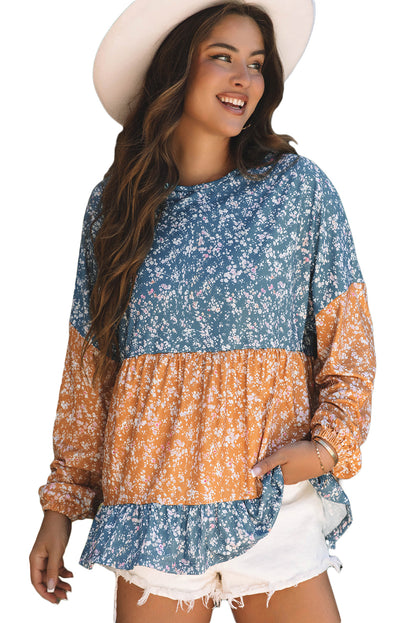 Orangefarbene Bluse mit Blumenmuster, Farbblockdesign, Rüschensaum und Rundhalsausschnitt
