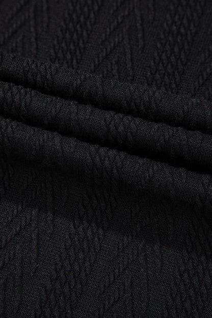 Schwarze Bluse mit V-Ausschnitt und floralem Patchwork-Muster