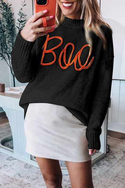 Schwarzer Pullover mit überschnittener Schulter und geripptem Rand und Boo-Strickmuster