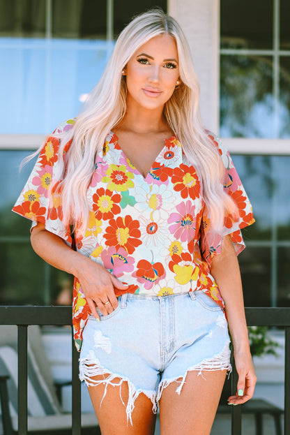 Orangefarbene Bluse mit V-Ausschnitt und halblangen Ärmeln und abstraktem Print