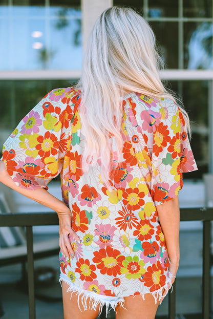 Orangefarbene Bluse mit V-Ausschnitt und halblangen Ärmeln und abstraktem Print