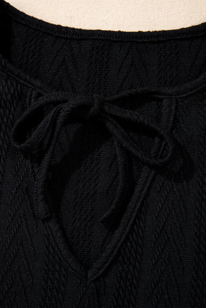 Schwarze Bluse mit V-Ausschnitt und floralem Patchwork-Muster