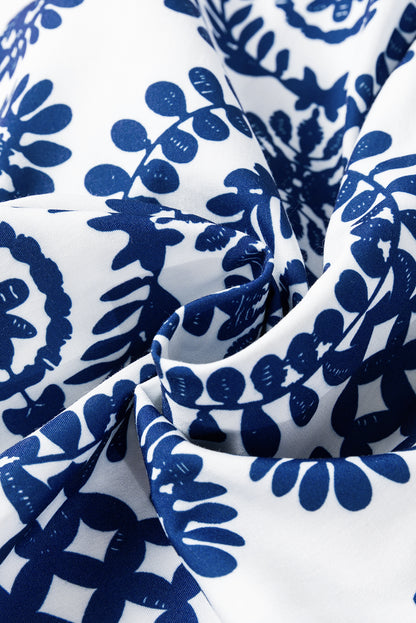 Blaues Kleid mit Blumenmuster, V-Ausschnitt, Wickelknoten und langen Ärmeln