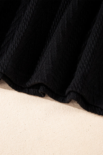 Schwarze Bluse mit V-Ausschnitt und floralem Patchwork-Muster