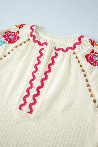 Beigefarbene Bluse mit floraler Stickerei und strukturierten Puffärmeln im Ricrac-Stil