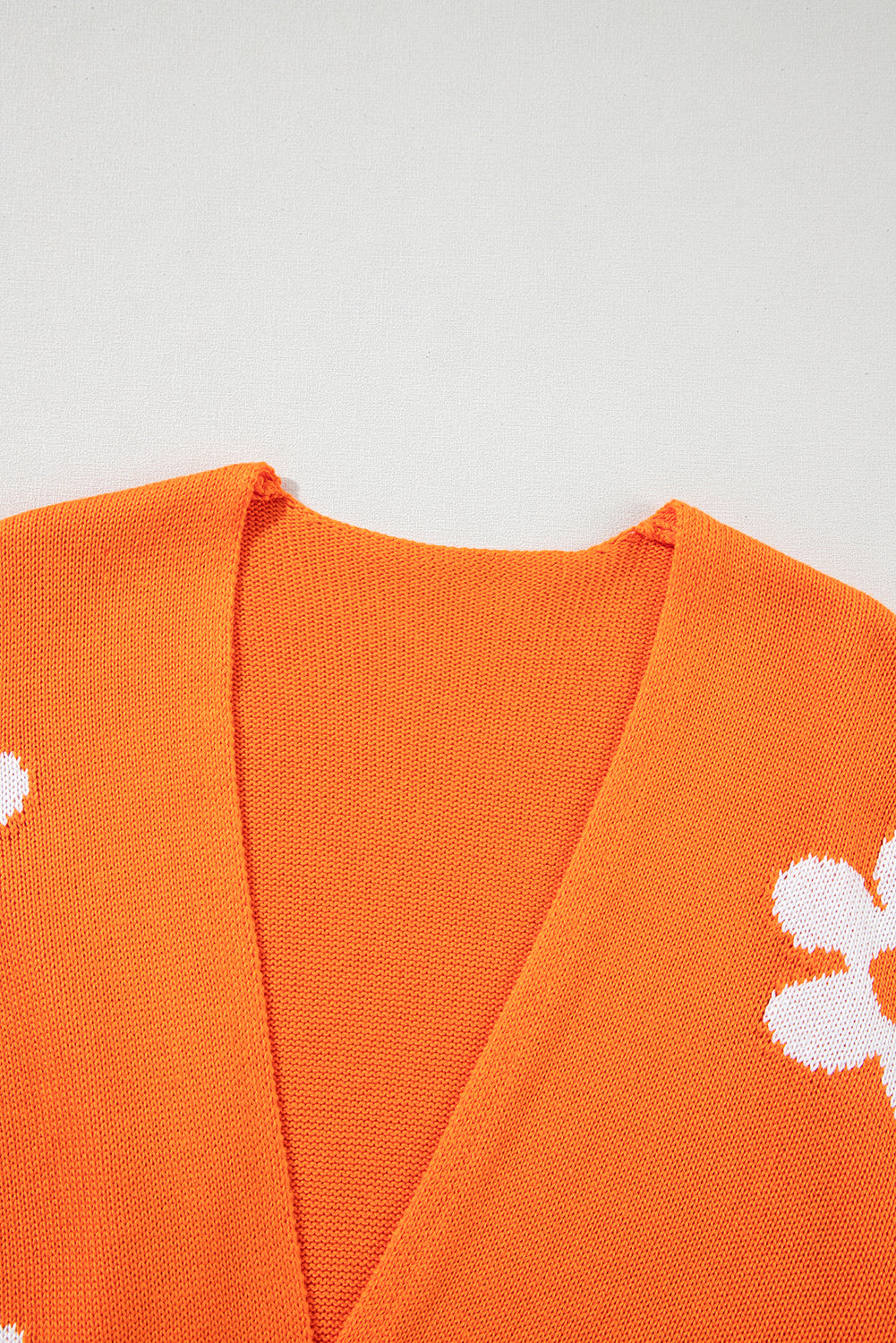 Orangefarbener, lockerer Strickcardigan mit Blumenmuster und offener Vorderseite
