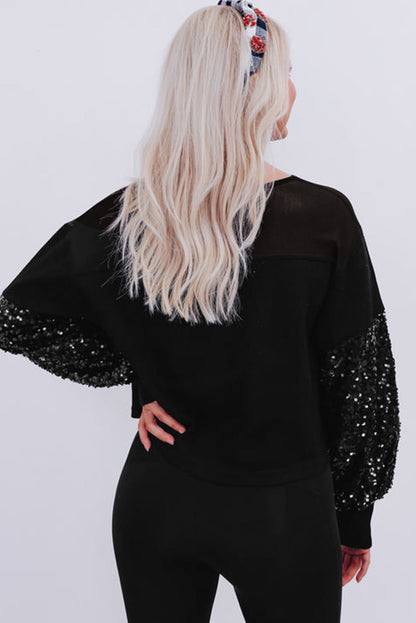 Schwarze Bluse mit Pailletten-Patchwork und Laternenärmeln