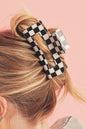 Schwarze Haarspange mit Karomuster und Aussparungen