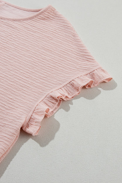 Hellrosa Bluse mit Rüschen und einfarbiger Struktur