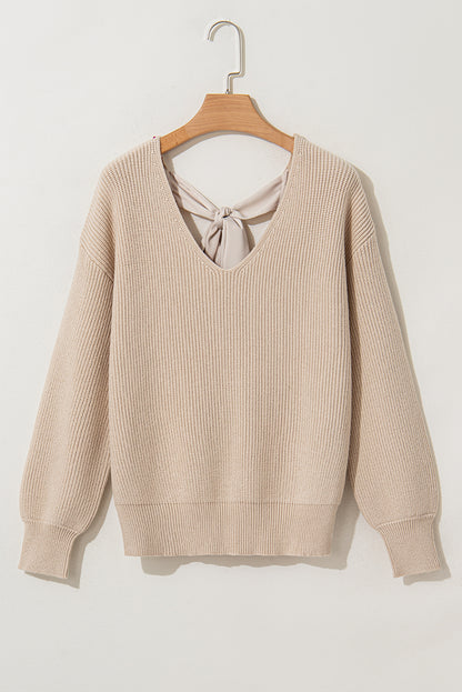 Aprikosenfarbener Pullover mit Laternenärmeln und V-Ausschnitt und Knoten hinten