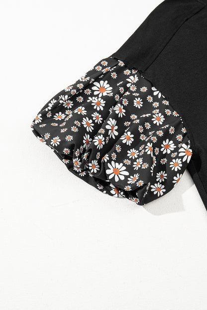 Schwarzes Oversize-Oberteil mit kontrastierendem Blumenmuster und Puffärmeln