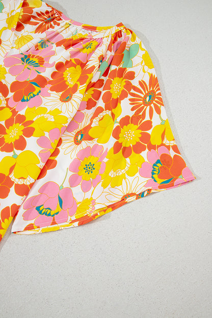 Orangefarbene Bluse mit V-Ausschnitt und halblangen Ärmeln und abstraktem Print