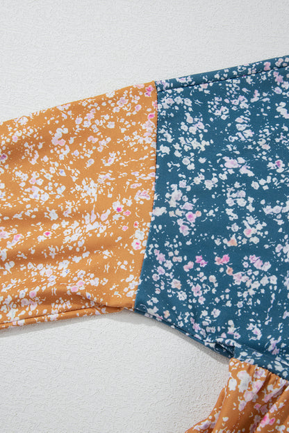 Orangefarbene Bluse mit Blumenmuster, Farbblockdesign, Rüschensaum und Rundhalsausschnitt
