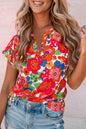 Feurig rotes Top mit Blumenmuster und Schlitz am Ausschnitt
