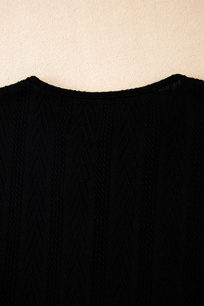 Schwarze Bluse mit V-Ausschnitt und floralem Patchwork-Muster