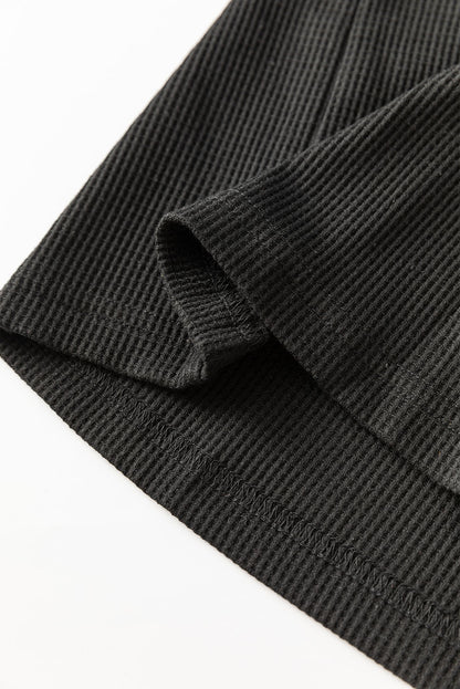 Schwarze Bluse mit Pailletten-Patchwork und Laternenärmeln