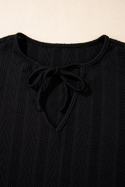 Schwarze Bluse mit V-Ausschnitt und floralem Patchwork-Muster