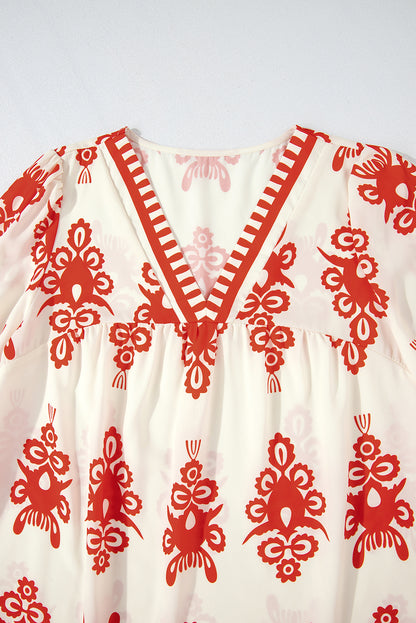 Orangefarbene Bluse mit 3/4-Ärmeln und V-Ausschnitt im Vintage-Stil mit geometrischem Muster
