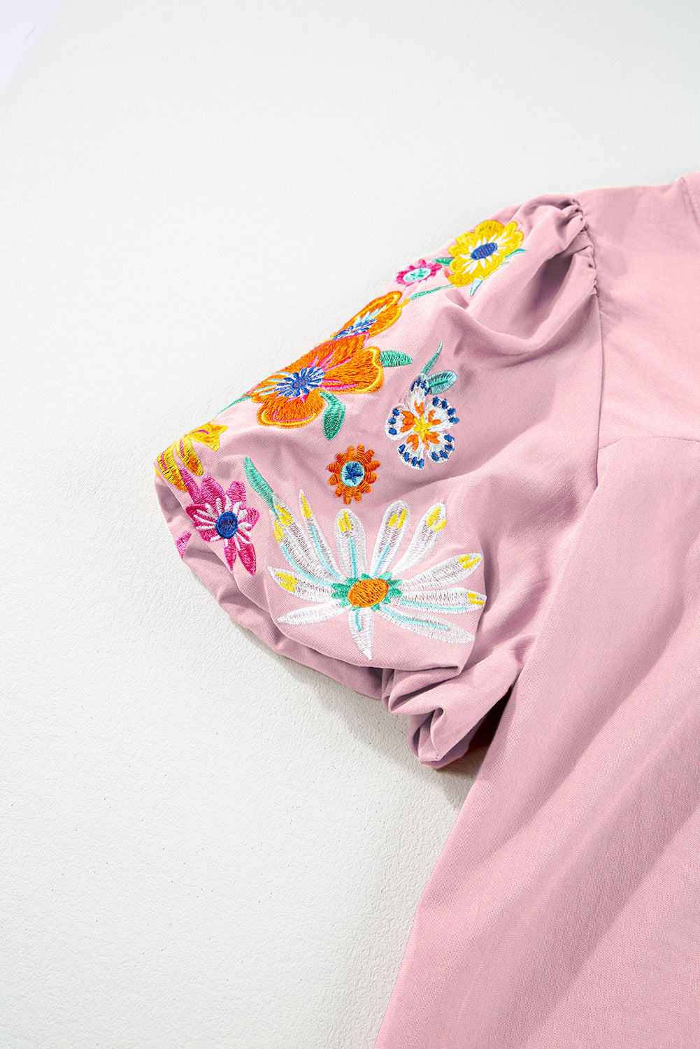 Rosa Bluse mit Blumenstickerei, Puffärmeln und Schlitz am Ausschnitt